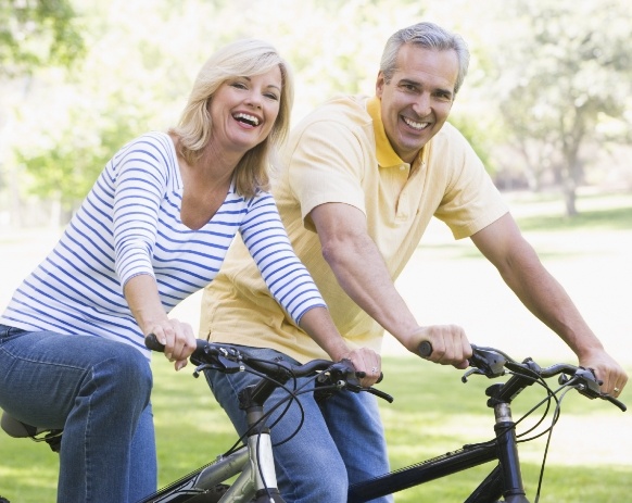 Older couple outdoors sharing healthy smiles