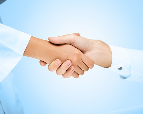 Close-up of dentist and patient shaking hands