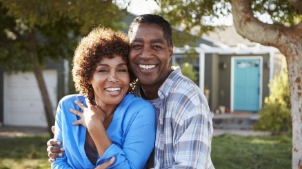 Man and woman with healthy smiles after restorative dentistry