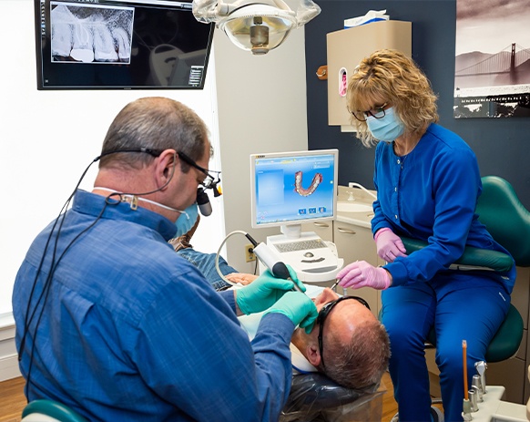 Dentist using intraoral camera to capture smile images