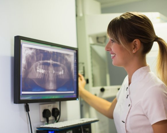 Dental team member looking at digital x rays