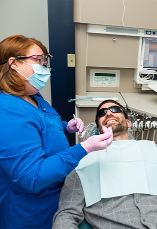 Woman smiling during preventive dentistry visit