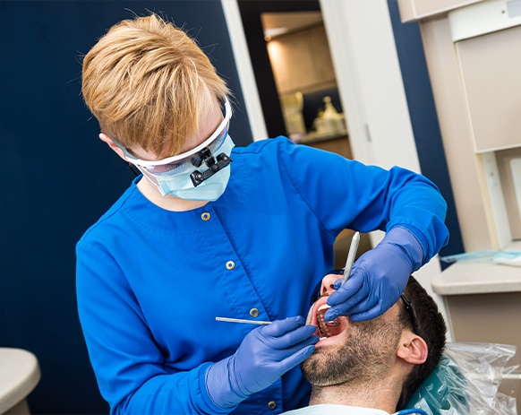 Dentist providing dental checkup and teeth cleaning