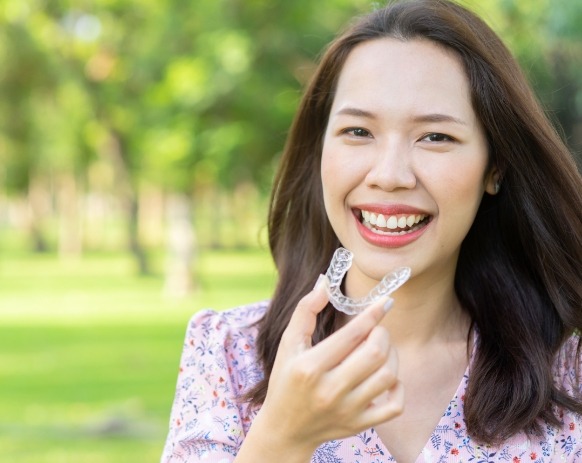 Woman placing an Invisalign tray