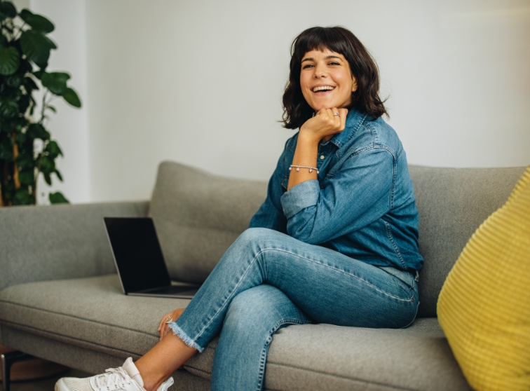 Woman in dental office waiting room smiling