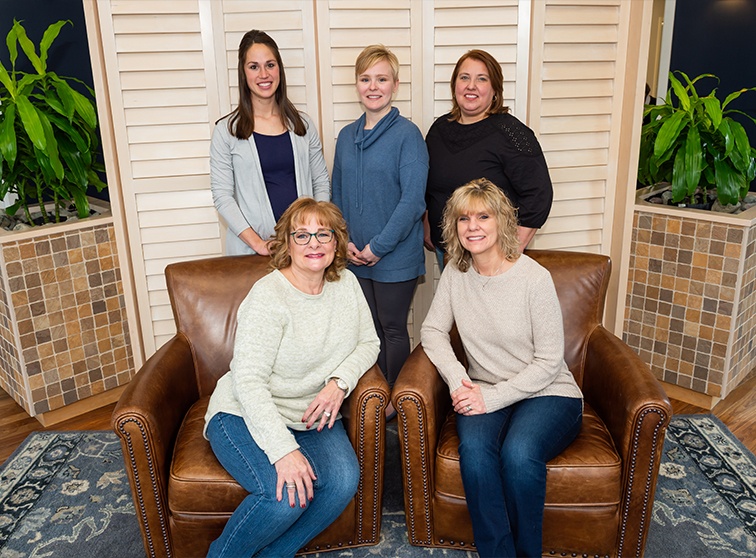 Dental team members sitting in reception area in Lancaster dental office