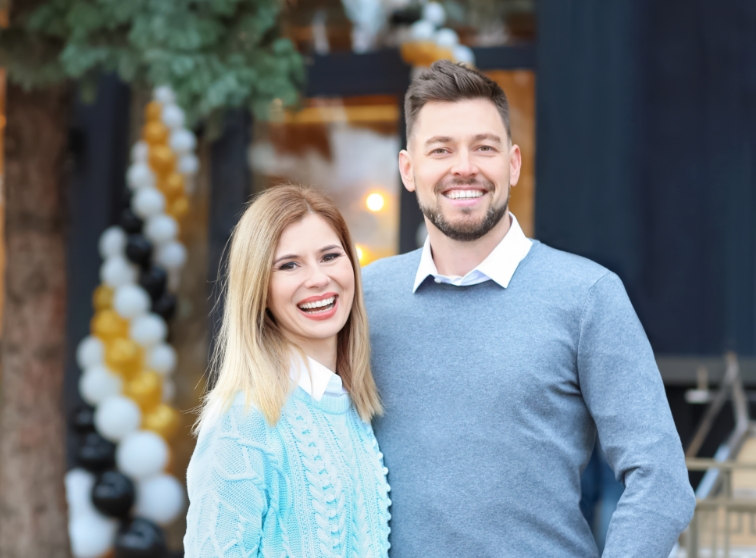 Man and woman smiling together outdoors