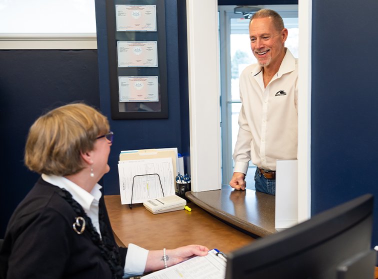 Dental team member talking to Lancaster dental patient at front desk