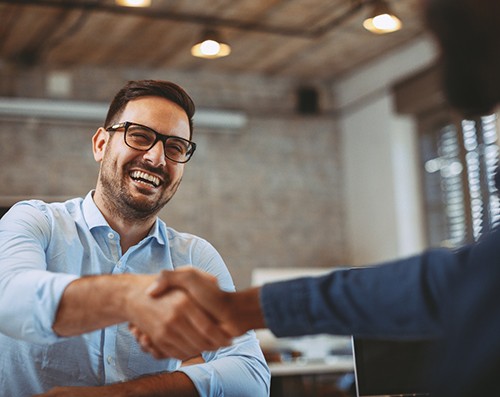 patient shaking hand of dental professional