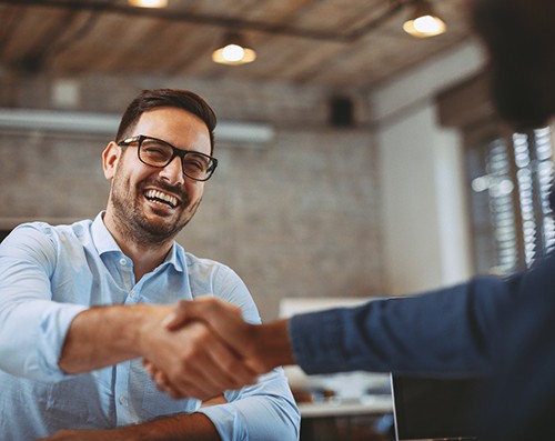 patient shaking hand of dental professional 