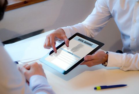 Patient reviewing dental insurance information with office manager