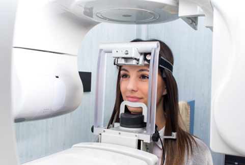 Patient with her head positioned in CBCT scanner
