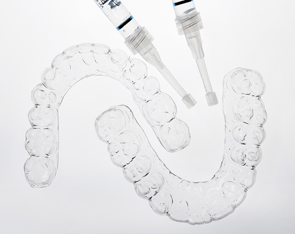 Custom teeth whitening trays against neutral background