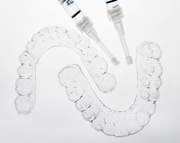 Custom teeth whitening trays against neutral background