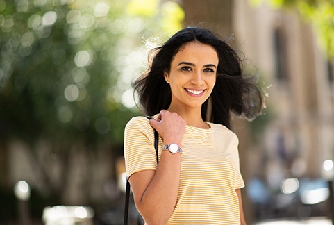 Woman in striped shirt outside and smiling