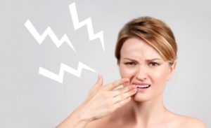 Woman experiencing intense dental sensitivity