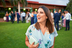 a person smiling while attending a ceremony