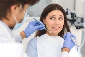 Woman looking worried at dentist. 